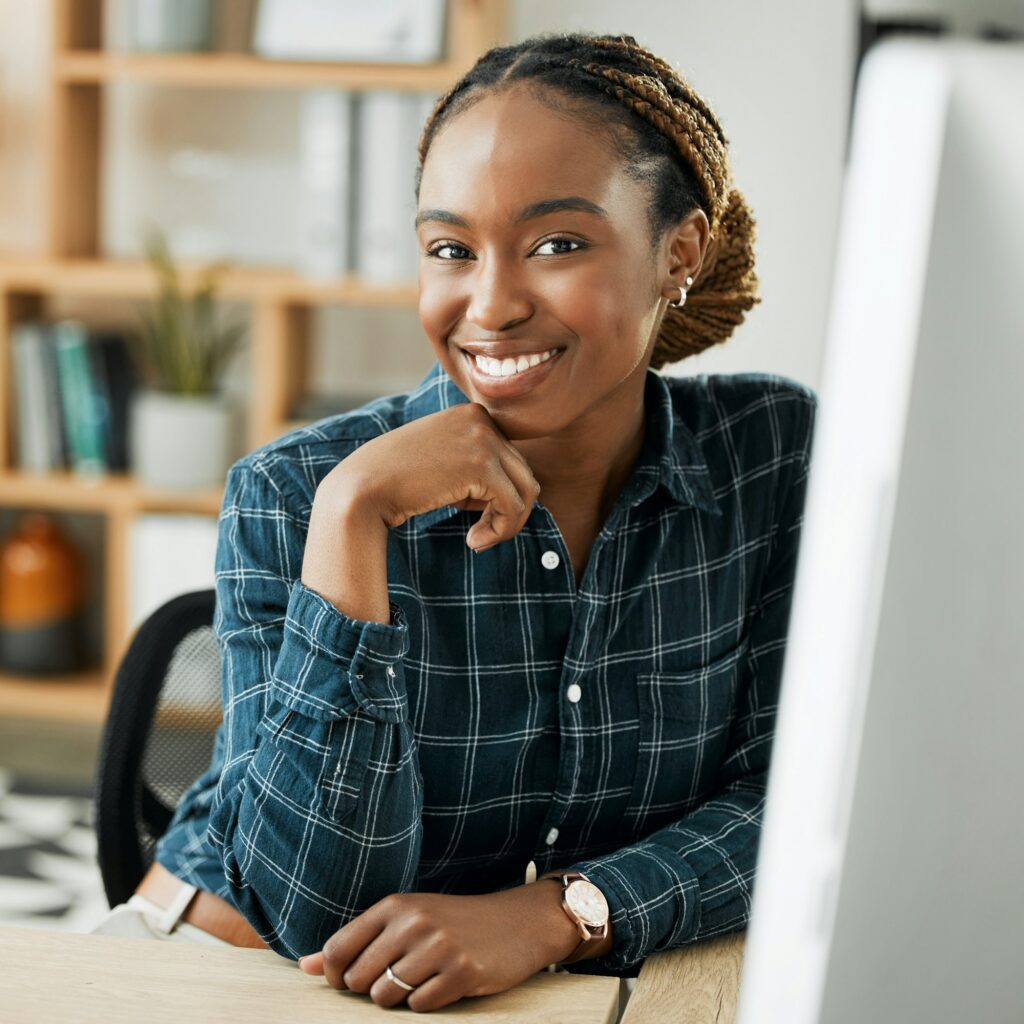 Portrait, business and black woman with a computer, smile and confident employee in a workplace, ca